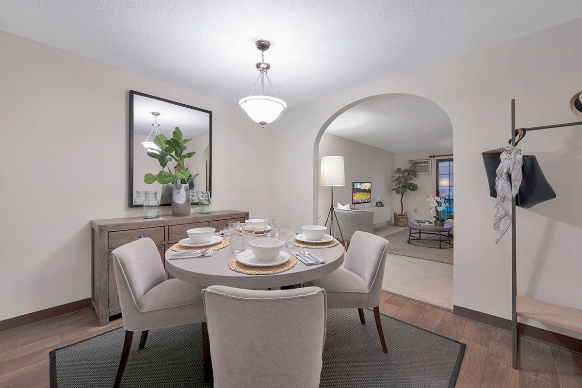 a designer apartment dining room with a silver light fixture